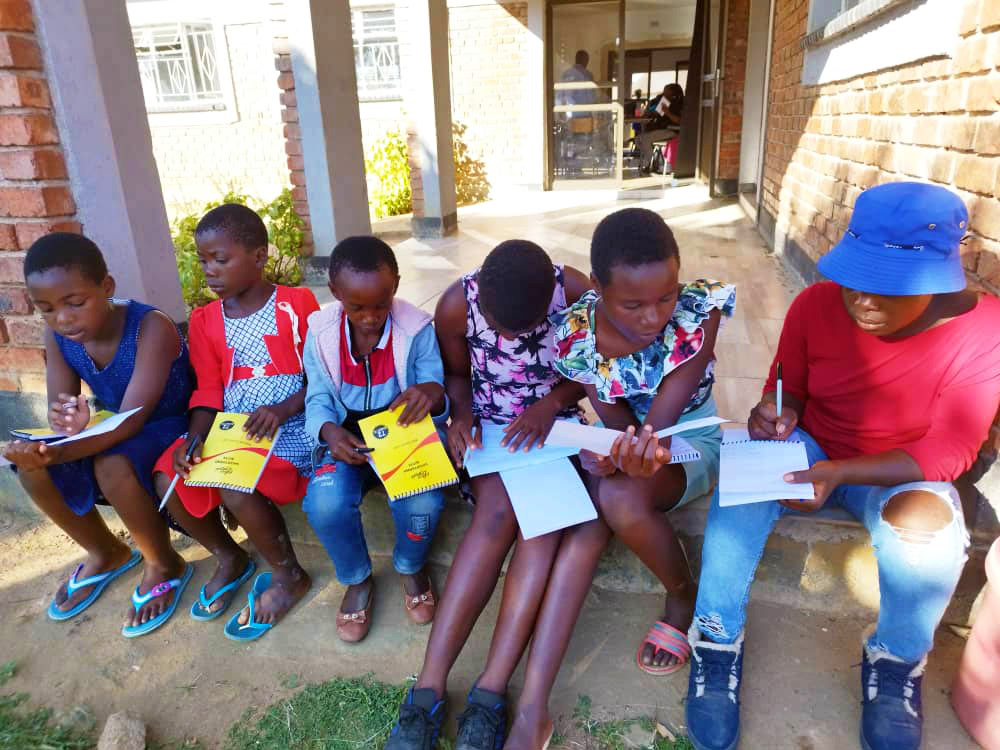 A group of girls participating in a workshop group discussion